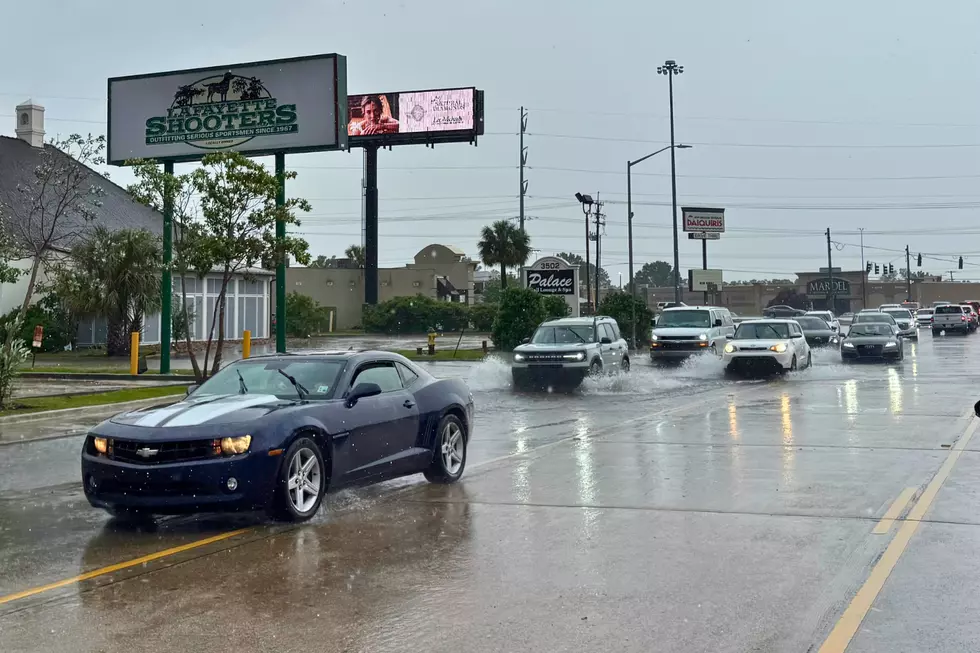 A flooded street and traffic cones highlight Lafayette, LA road closures