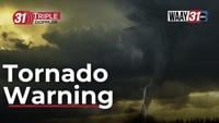 Aftermath of tornado in Huntsville, AL showing damaged buildings and debris